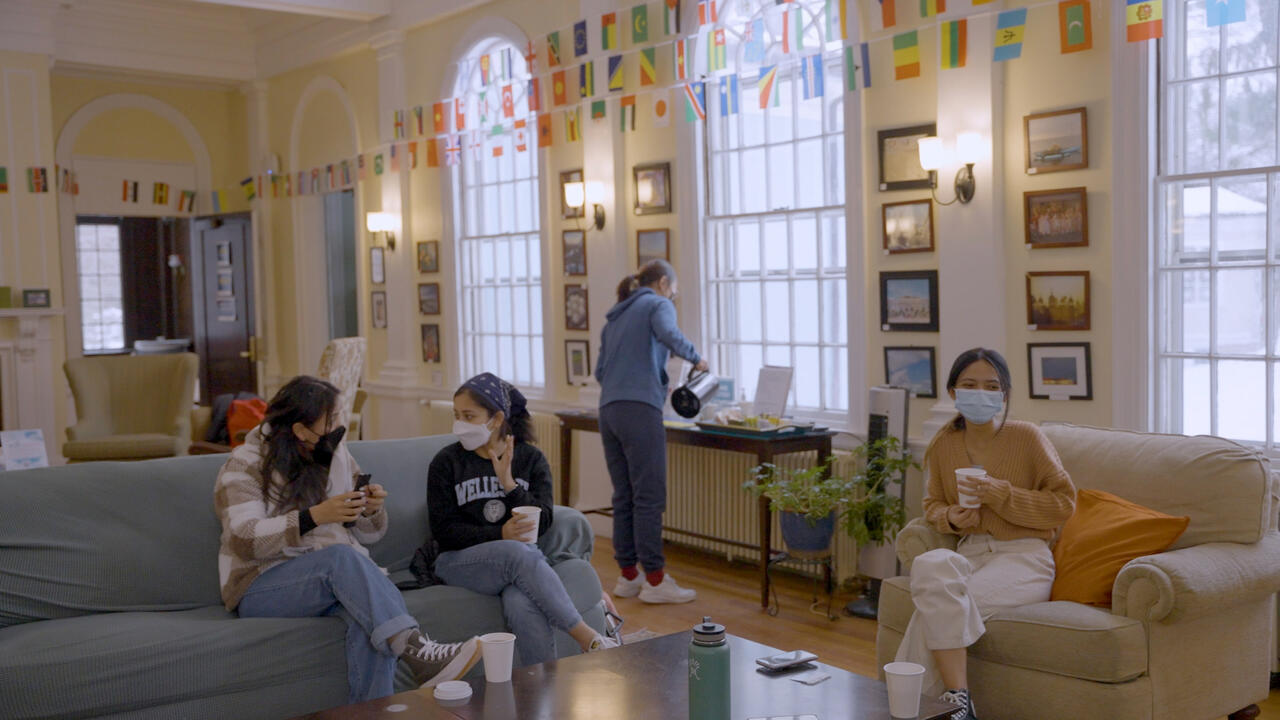 Students sit and chat inside Slater House.