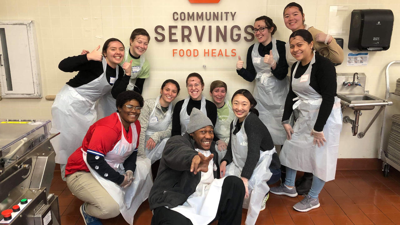 A group photo of students at Community Servings, a Boston nonprofit that cooks and delivers food.