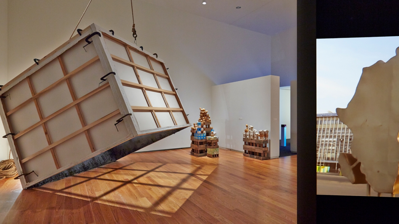 A box tilts on its axis in an art space.