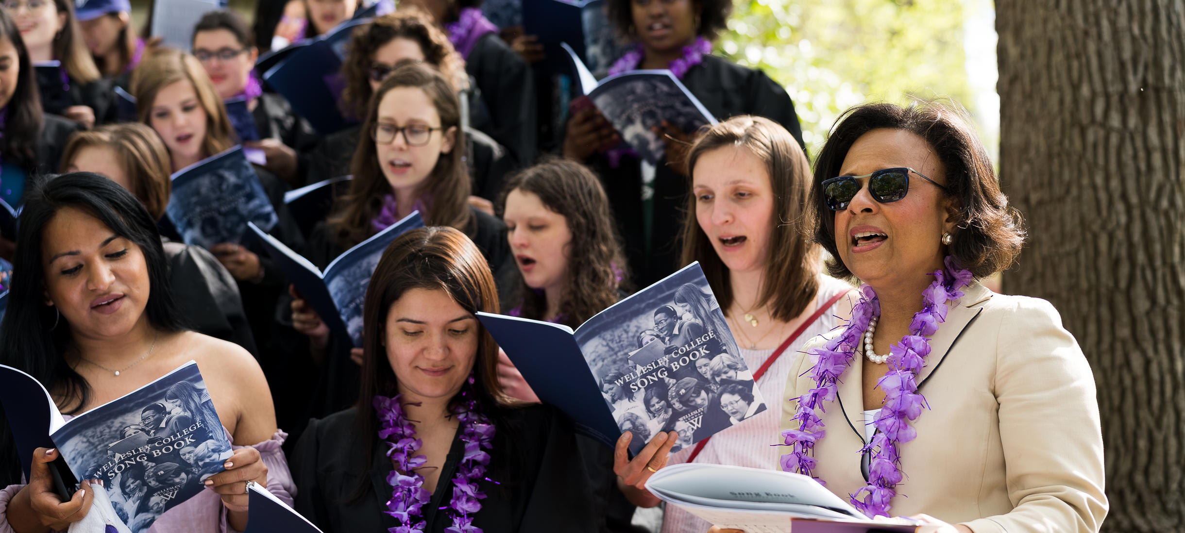 Picture of President Paula Johnson, students, singing, Wellesley College songbook.