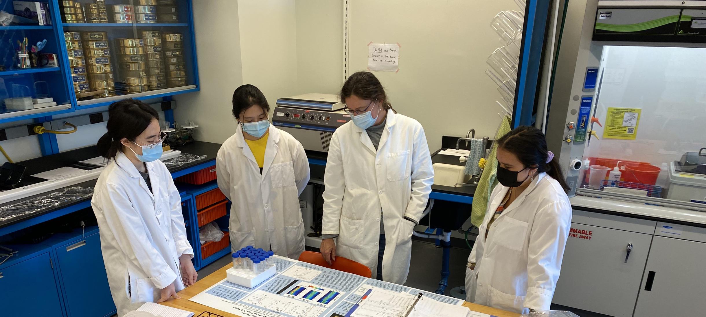 Lab group members examine sediment data