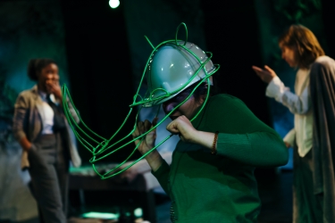 An actor wearing a rhino headpiece.