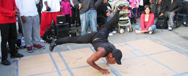 guy breakdancing on cardboard